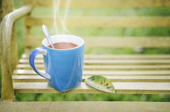 Cup Of Hot Coffee With Nuture Background.