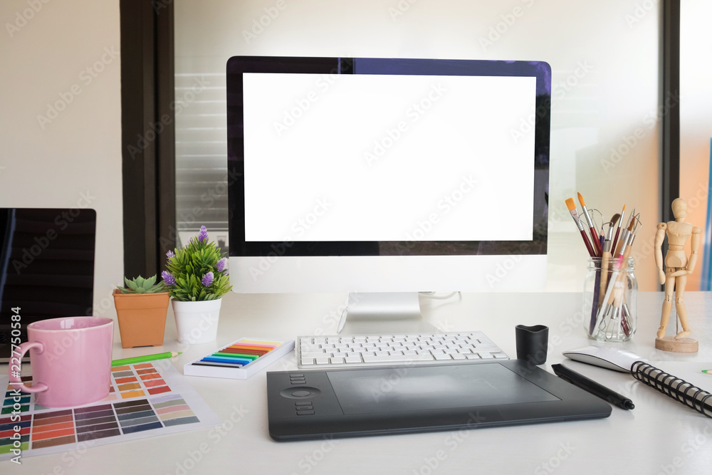 Fototapete Mockup artist workplace with computer pc and cup of coffee on desk with empty screen computer display.