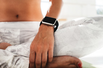 Fitness woman after workout session checks results on smartwatch in fitness app. Healthy lifestyle...