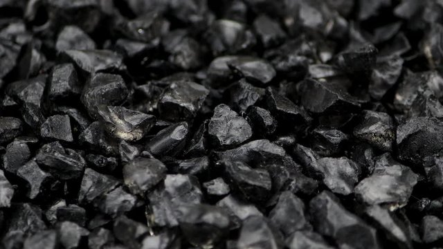 Black split stones rotate on a turntable