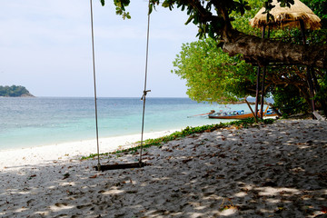 Silhouette swing with sea beach view.