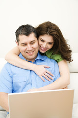 happy couple using laptop