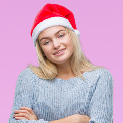 Young caucasian woman wearing christmas hat over isolated background happy face smiling with crossed arms looking at the camera. Positive person.