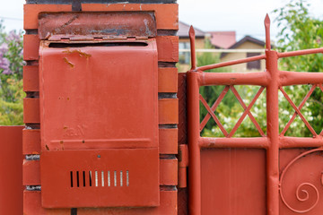 A beautiful mailbox hangs waiting for newspapers, parcels and letters.
