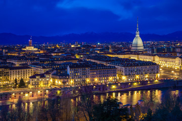 Fototapeta na wymiar Panoramic view of Turin with Mole Antonelliana against snow capped Alps at dusk, Turin, Italy