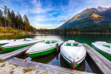Fantastic autumn evening at Hintersee lake. Few boats on the lake