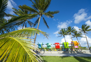 Row of brightly colored traditional wooden lifeguard towers waiting for placement on South Beach, Miami, Florida, USA