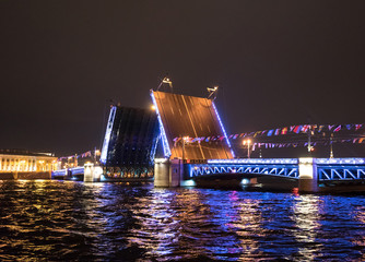 Fototapeta na wymiar Brightly lit divorced Palace Bridge at night in St. Petersburg. Russia