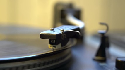 retro style memories concept female hand putting needle on old vinyl recor player