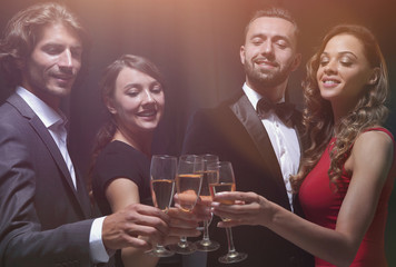Cheerful people celebrating a sucess with Champagne