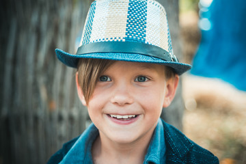 Little boy advertises natural products. The boy advertises children's clothes for the autumn. Happy child at the autumn fair. Bye summer - hi autumn.