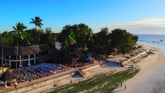 Aerial panorama shot of tropical island in the ocean. Exotic paradise at sunset. Feelings and emotions of summer vacation. 4K (UHD).