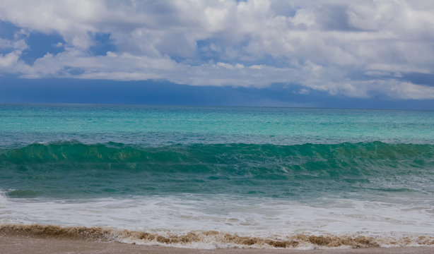 A Green Blue Wave On The Beach