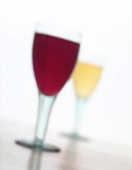 ABSTRACT IMAGE OF RED WINE AND WHITE WINE GLASSES ON WHITE BACKGROUND