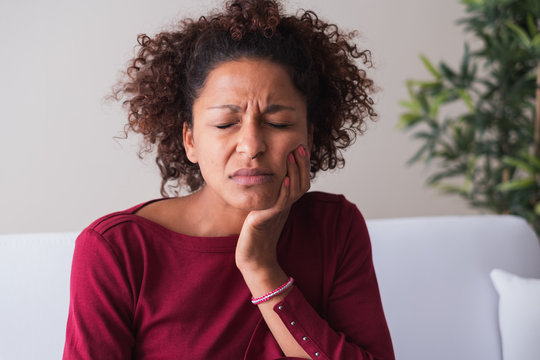 Woman Feeling Toothache And Massaging Gums