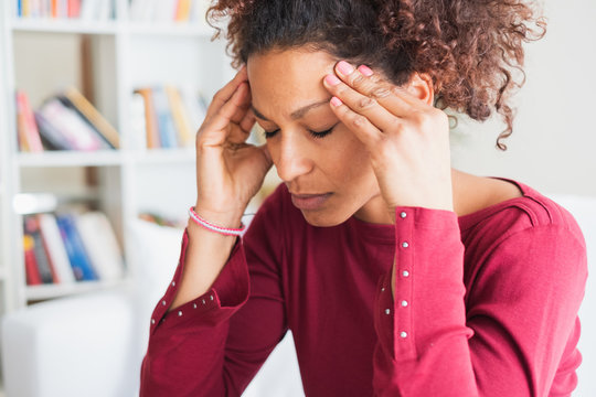 Young black woman suffering strong headache