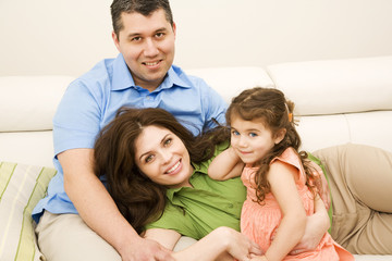 Obraz premium portrait of happy family sitting on sofa at home