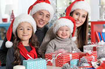 Portrait of family in Santa hats preparing for Christmas