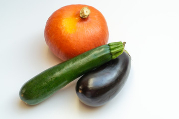 Pumpkin, eggplant and courgette on white background
