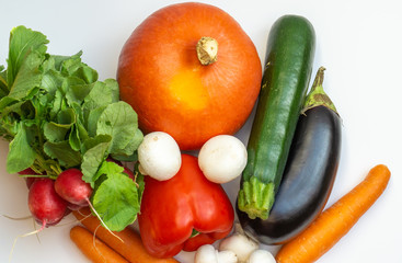 Pumpkin, eggplant, carrots, mushrooms, pepper, radish and courgette on white background
