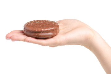 Chocolate sandwich cookie in hand on white background isolation