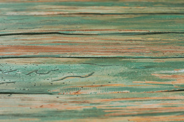 Old shabby wooden fence background. Rustic boards with shabby green paint. Aged timber surface.