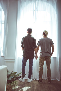 I can see our future. Full length back view portrait of two young men staring off in the same direction