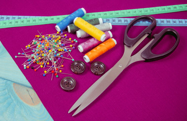 Supplies and accessories for sewing - scissors, threads, pins, buttons, centimeter.