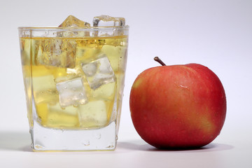 Apple Juice dripping flowing through frosted glass ice cube