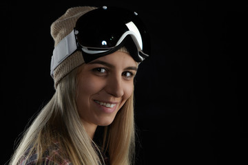 Snowboarding and skiing concept. Picture of cheerful beautiful young sporty girl with long loose blonde hair looking and smiling at camera, going to ride in mountains, feeling happy and excited