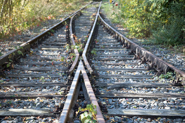 two railway tracks come together with railroad switch