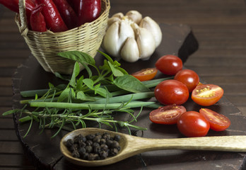 Herbs, garlic, spicy on wood background.