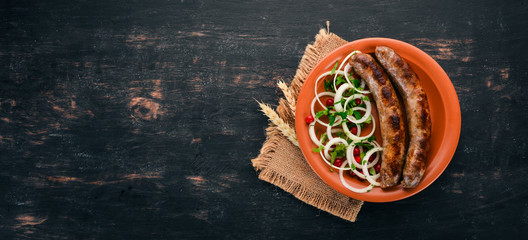 Baked sausage grill. Barbecue. On the old wooden background. Free space for text. Top view.