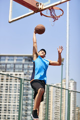 young asian adult dunking © imtmphoto