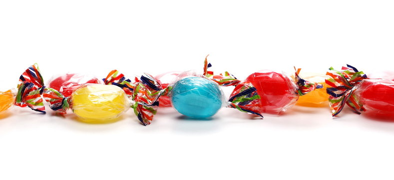 Colorful candies with transparent cellophane wrapping isolated on white background 