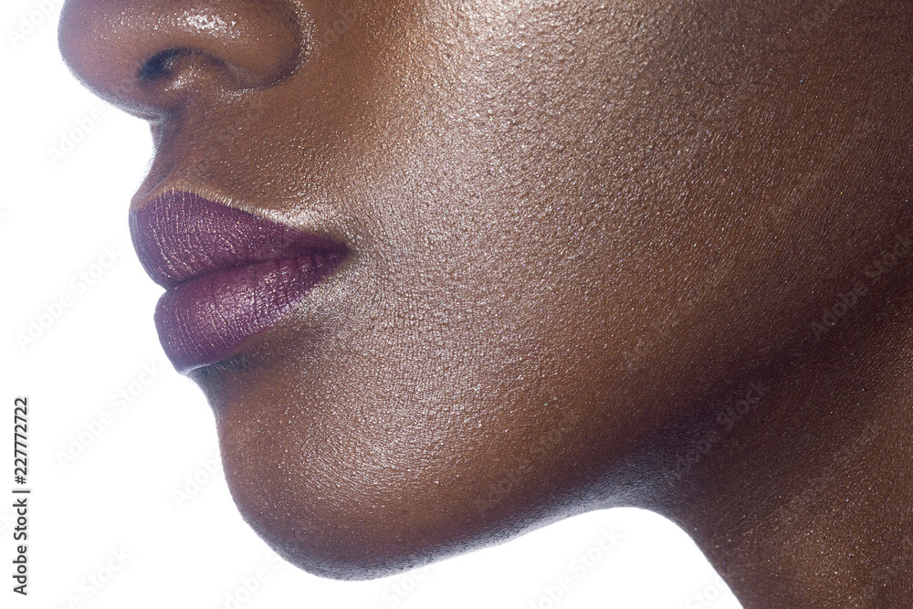 Wall mural Lips of young beautiful black woman with clean perfect skin