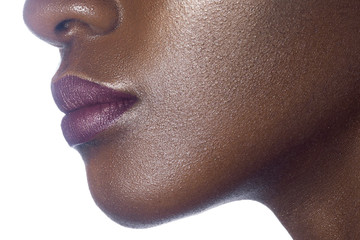 Lips of young beautiful black woman with clean perfect skin