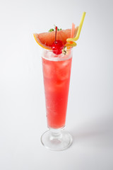 Alcohol fresh grapefruit cocktail with cherry and mint on white background