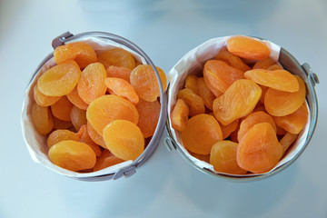 Dried apricots in the bowl . Bowl with dried apricots on white background