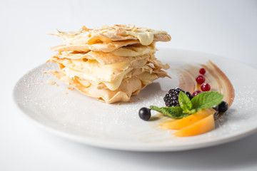 Crispy napoleon with almond chips and berries and mint