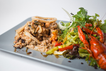 Seafood salad with squid, crayfish, mussels and green