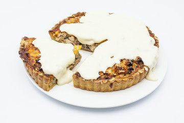 Chicken pie with mushrooms, cheese and garlic sauce on white plate