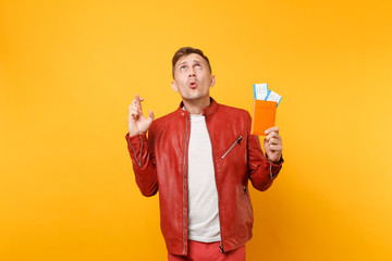 Portrait vogue smiling handsome young man in red leather jacket t-shirt hold passport tickets...