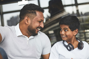 Overjoyed smiling hindu man looking at his son while enjoying time together