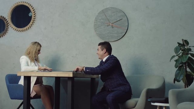 Angry female boss scolding employees for poor discipline and flirt at company office. Stressed employees receiving rebuke for easy flirt at workplace, suffering from bad attitude of executive at work.