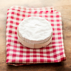 Cheese camembert on wooden desk, top view. Soft creamy cheese Brie with copy space.