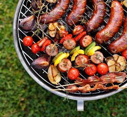Gardinen Grilled food. Various grilled products: Grilled sausages, meat and vegetable skewers, bacon and vegetables on the grill plate, outside. Barbecue, bbq © zi3000