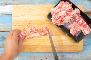 Chef slicing wagyu beef for cooking
