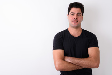 Young handsome Persian man against white background 