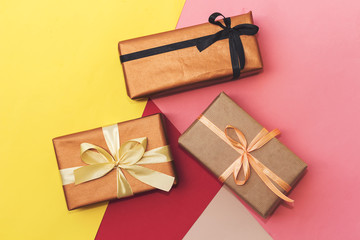 three rectangle gift boxes on different  colors paper for holiday